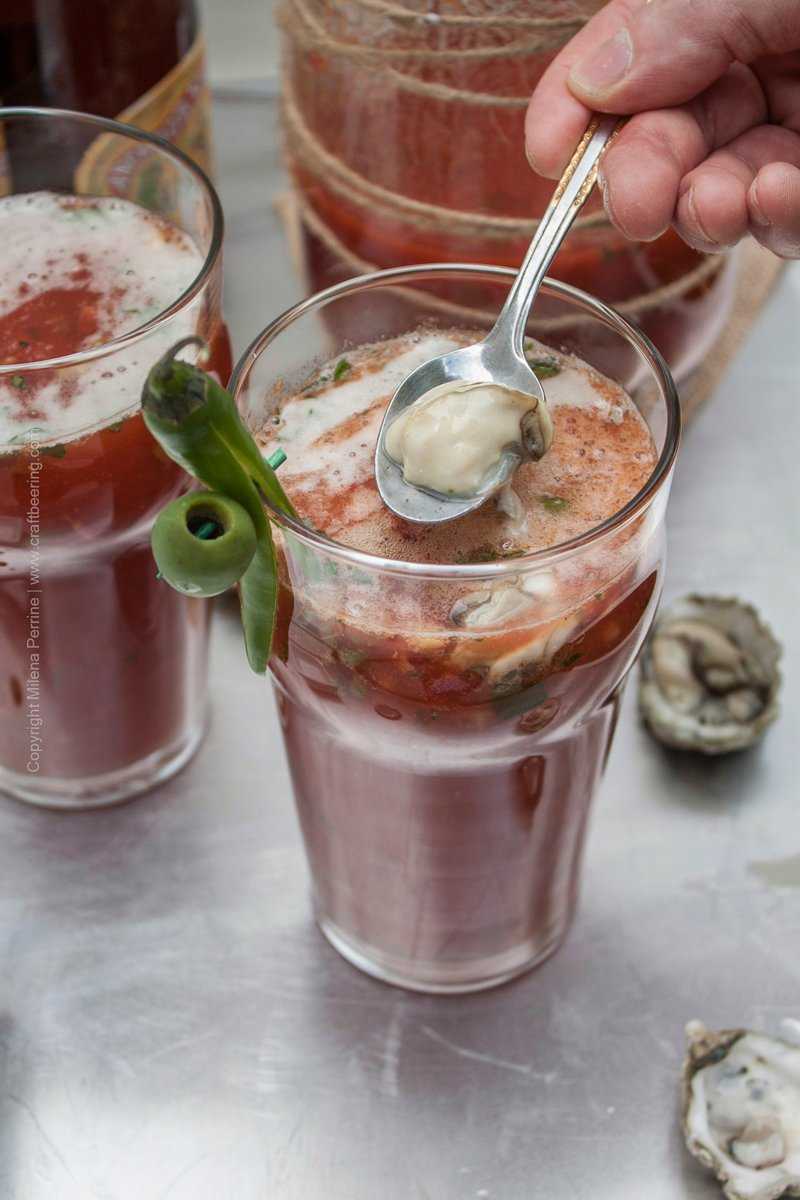Bloody Roman Cocktail. Gently sliding an oyster into the mix.