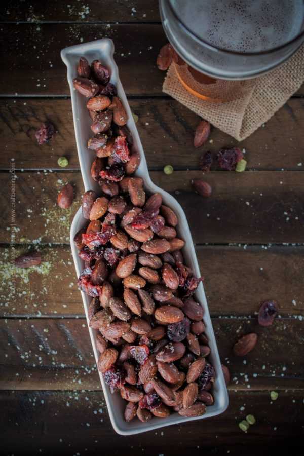 Roasted almonds with dried cranberries flavored by hops salt and served in a bottle shaped dish:) #roastedalmonds