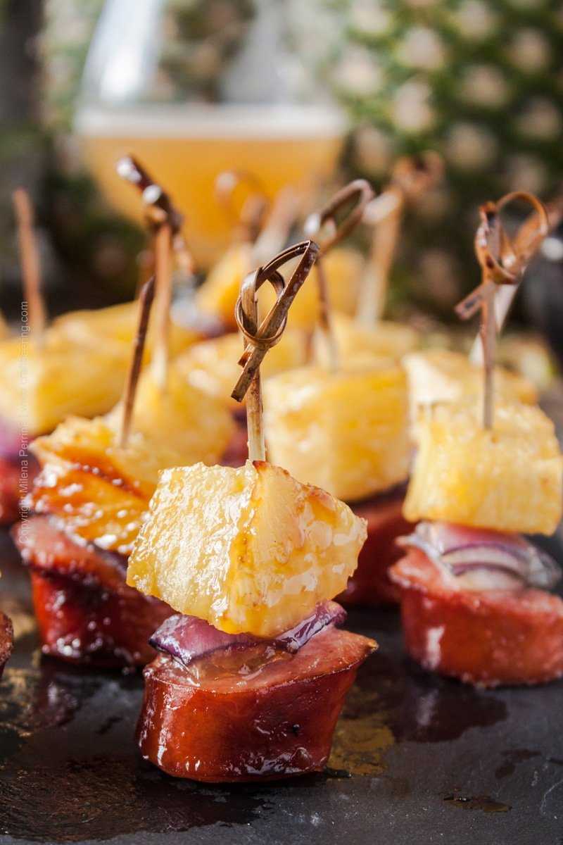Pineapple sausage bites glazed with juicy IPA and brown sugar. Oh man! The flavor and aromas in this pineapple recipe are unbeatable. #pineapplerecipe #summerrecipe #pineapplesausage #bites #easyappetizers