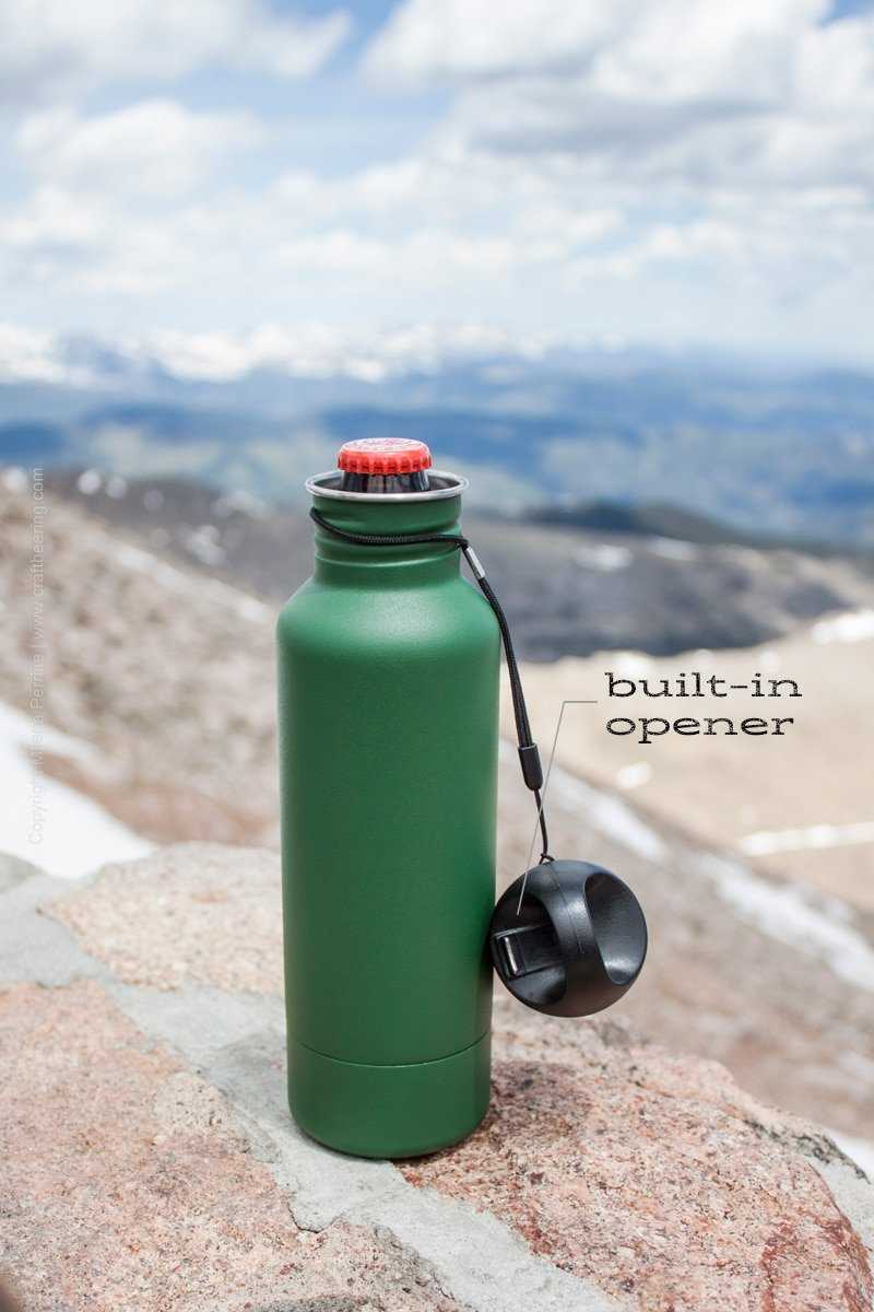 Beer bottle koozie with a built in opener in the tethered cap