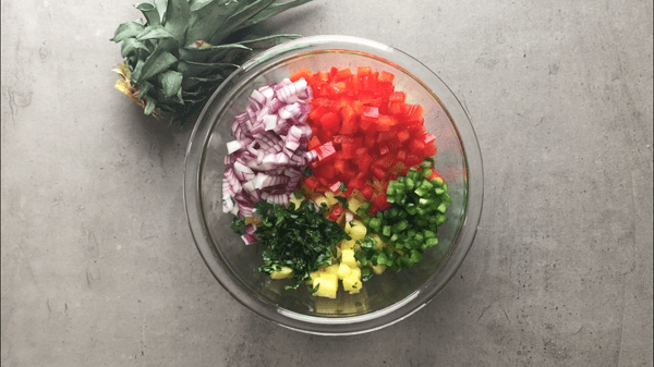 Ingredients for pineapple salsa - red pepper, onion, jalapeno and cilantro are added to the pineapple. 