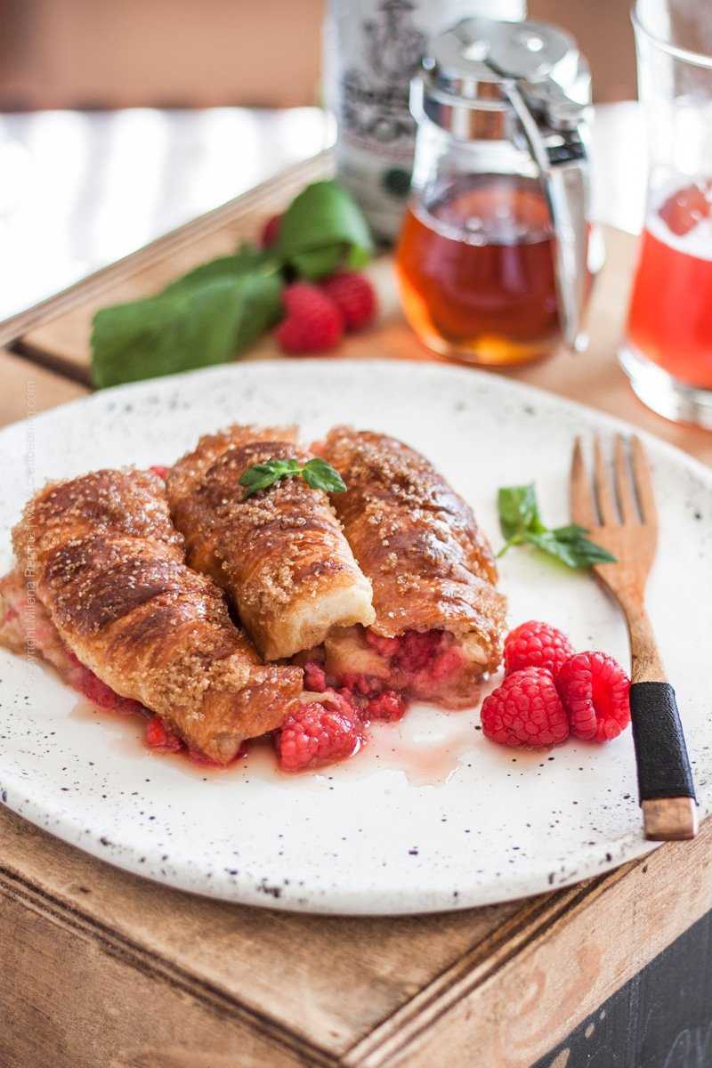 Croissant French toast stuffed with fresh raspberries and served with maple syrup. 