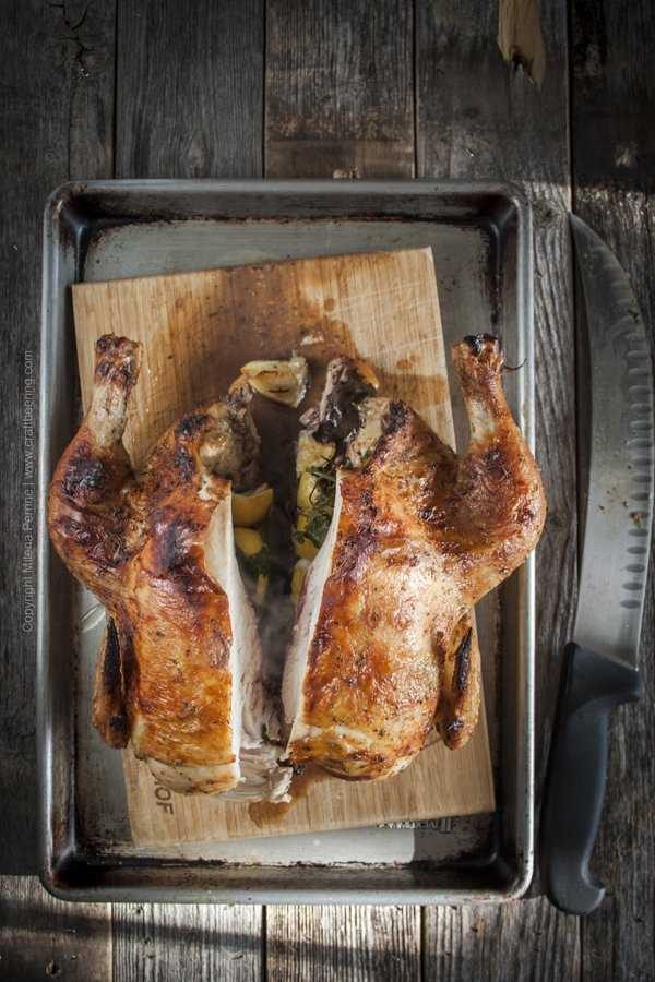 Whole roasted chicken sliced in half. All that fragrant steam coming from the herbs, lemon and garlic stuffed int he cavity!
