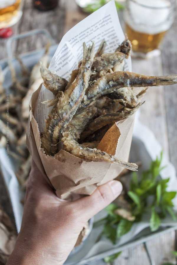 Fried anchovies or fried smelt served casual style in a paper cone. 