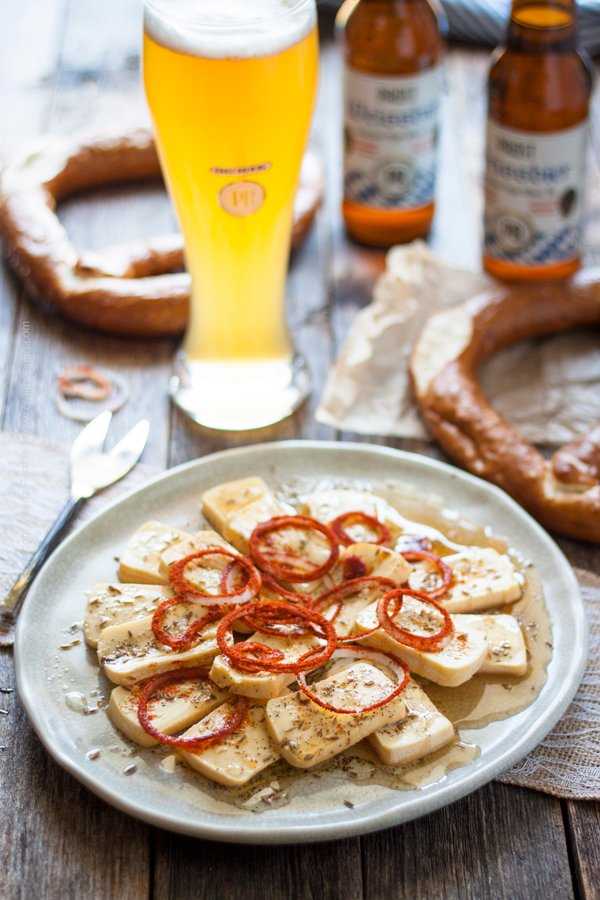 Limburger cheese presented as a salad with paprika coated onions and paired with Weissbier.