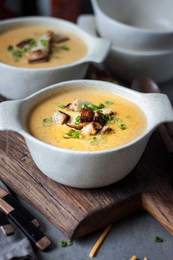 Beer cheese soup topped with homemade croutons and green onions