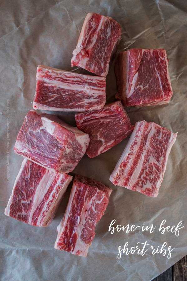 Raw bone-in beef short ribs, nicely marbled, perfect for slow cooking