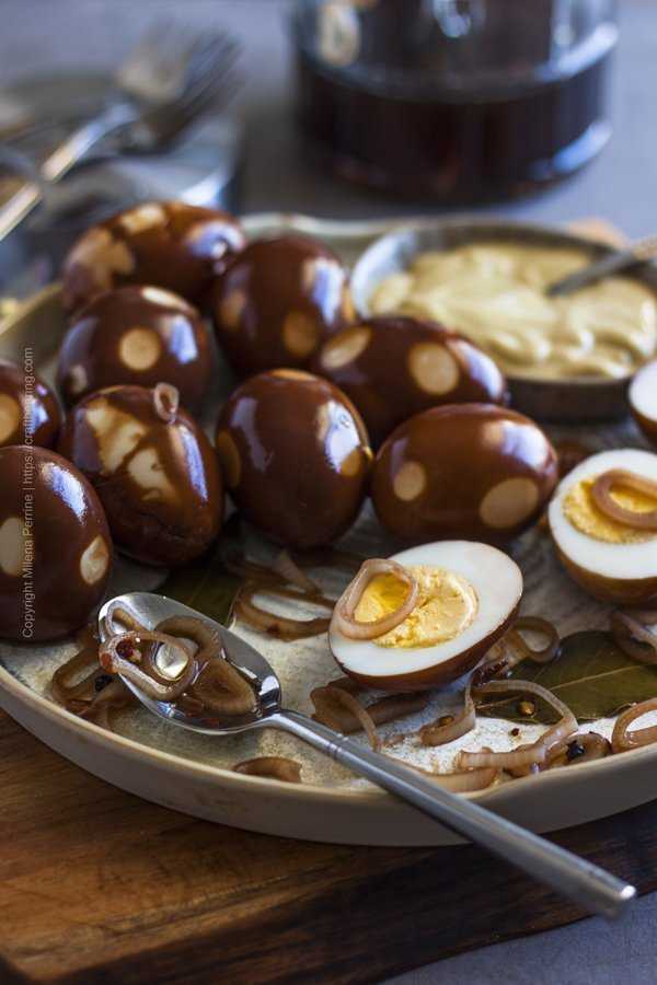 Spicy pickled eggs with balsamic, served with shallots and mustard. 