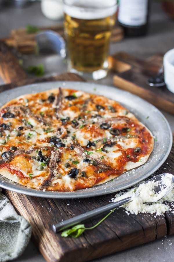 Anchovies pizza with olives, capers, marinara and mozzarella.