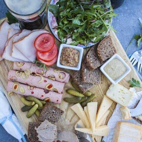 German appetizers - a meat and cheese board featuring popular German choices like Li,burger and leberwurst.