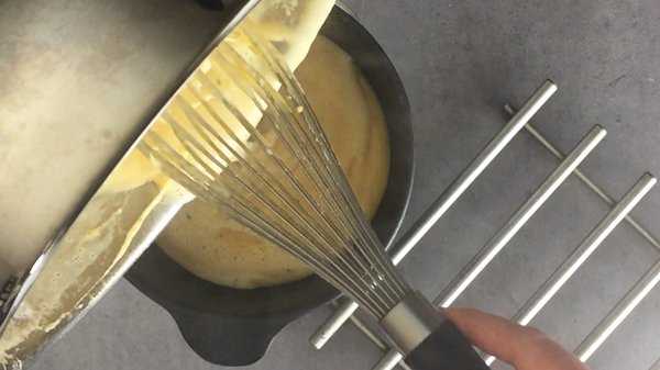 Beer cheese sauce transferred to a fondue pot.