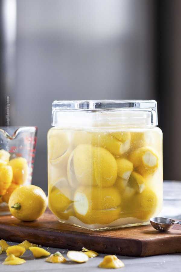 Tall jar with quartered salt preserved lemons. 