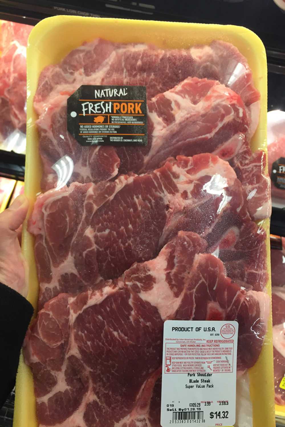 Raw pork shoulder blade steaks, packaged for sale.
