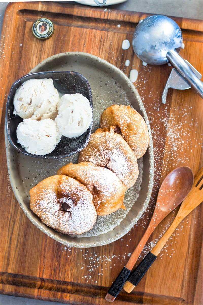 Apple fritters dusted with sugar and served with walnut ice cream.