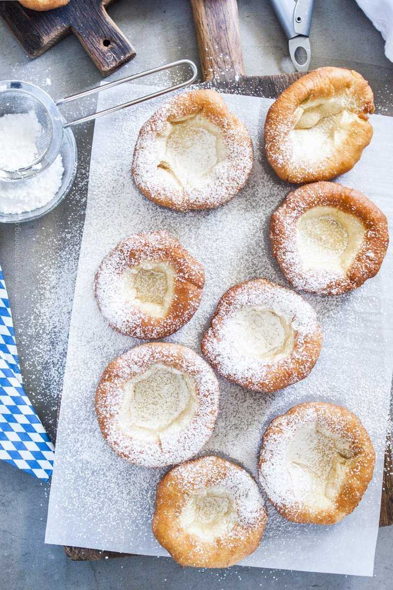 Traditional Bavarian donuts dusted with powdered sugar.