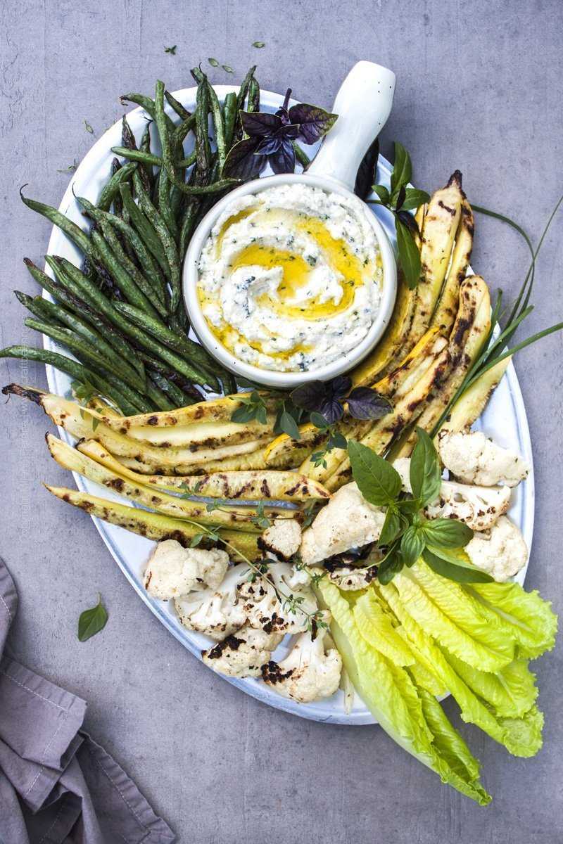 Herbed ricotta dip topped with extra virgin olive oil and served with vegetables.