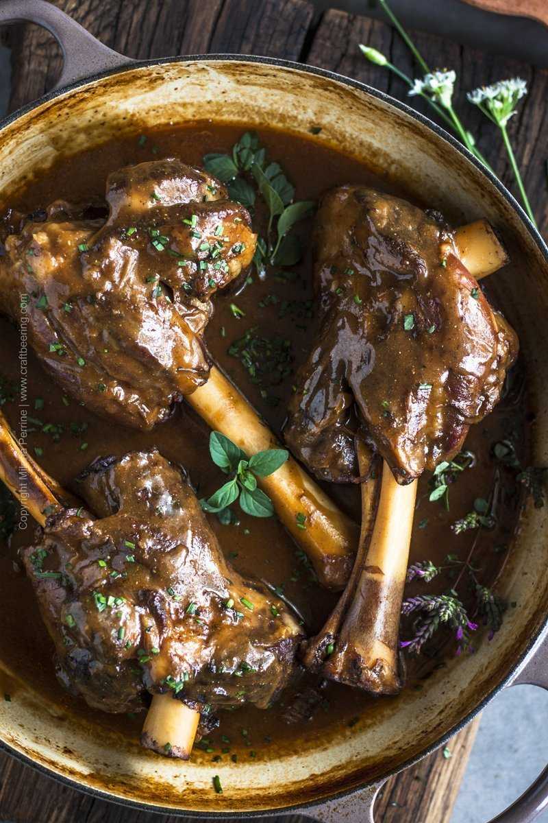 Beer braised lamb shanks smothered in gravy made with their own braising juices. 