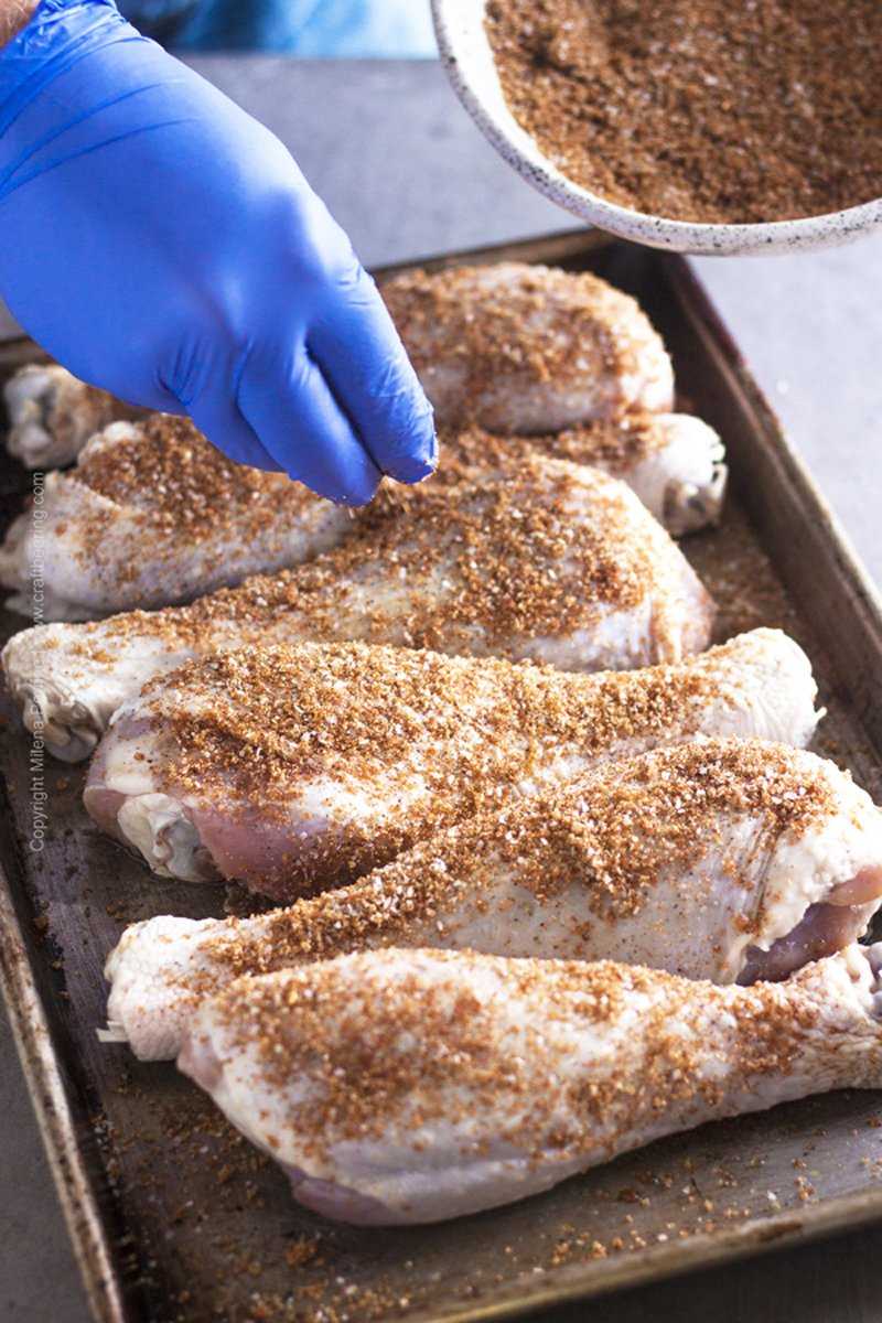 Seasoning already brined turkey legs with a dry rub before smoking them. 