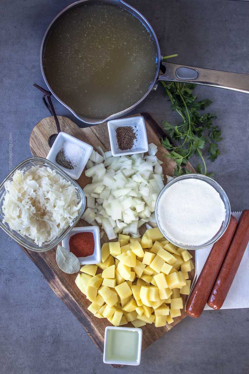 Ingredients for German sauerkraut soup with potatoes and smoked sausage.
