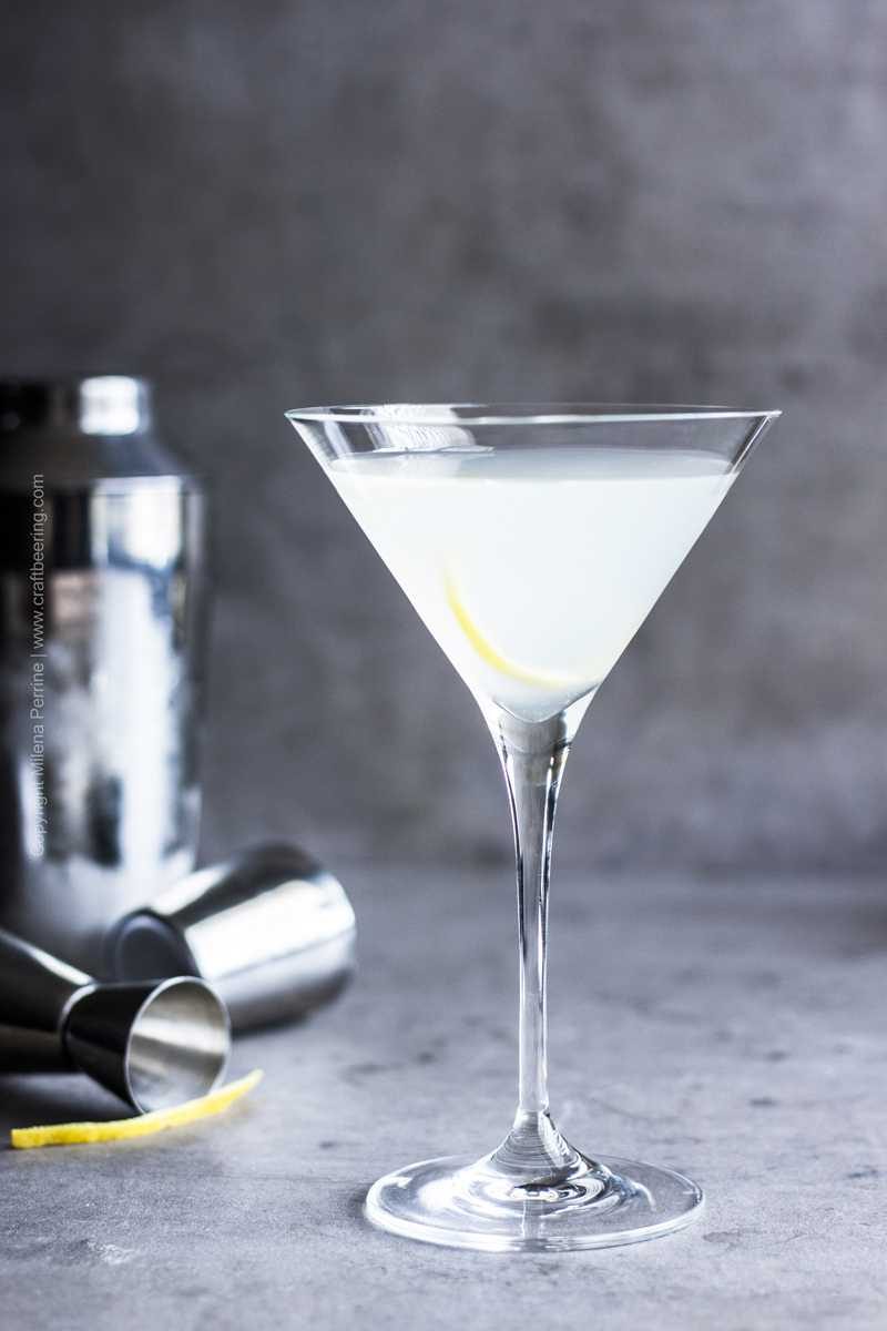 Dirty sauerkraut martini cocktail with lemon twist.