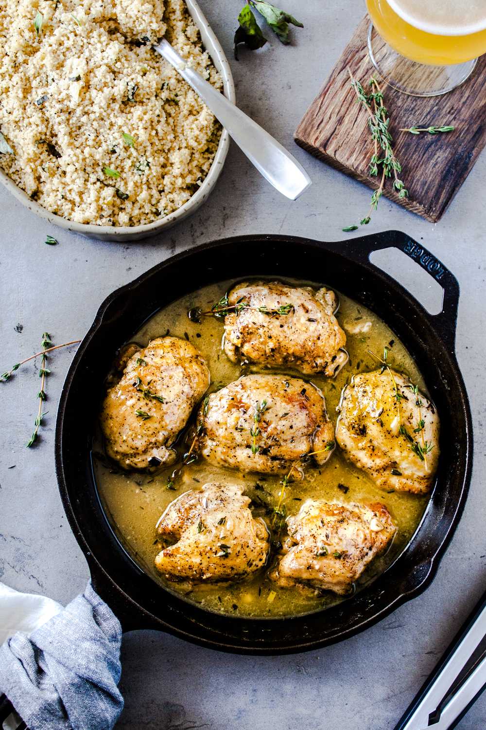 Beer chicken thighs in cast iron skillet. Use boneless skinless chicken thighs and a Belgian ale for the pan sauce, serve alongside herbed couscous.