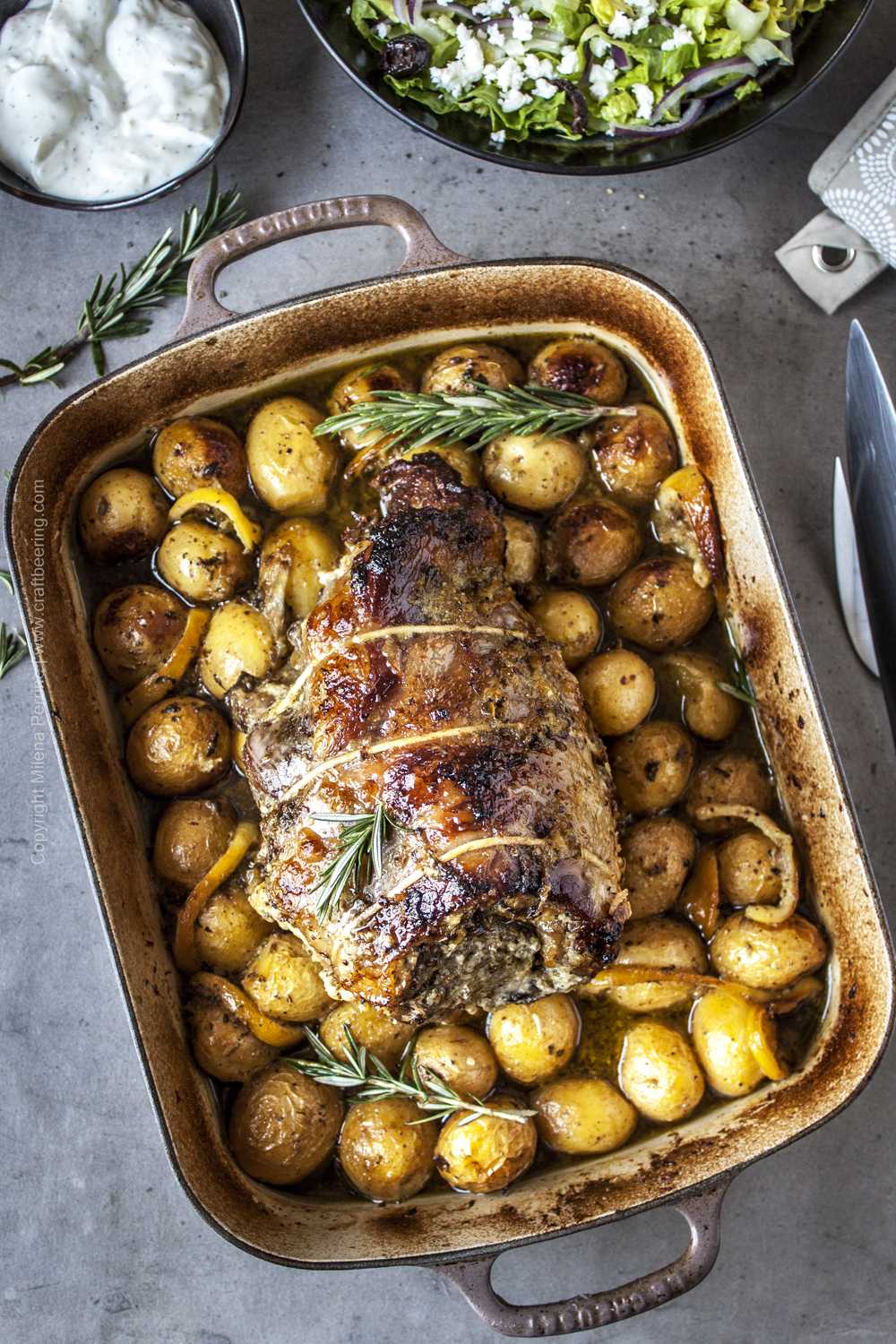 Roast boneless lamb shoulder with potatoes, rosemary, garlic.