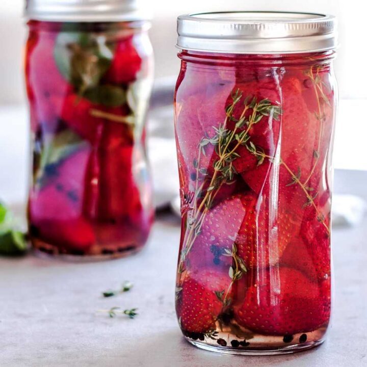 Quart jar with pickled strawberries.