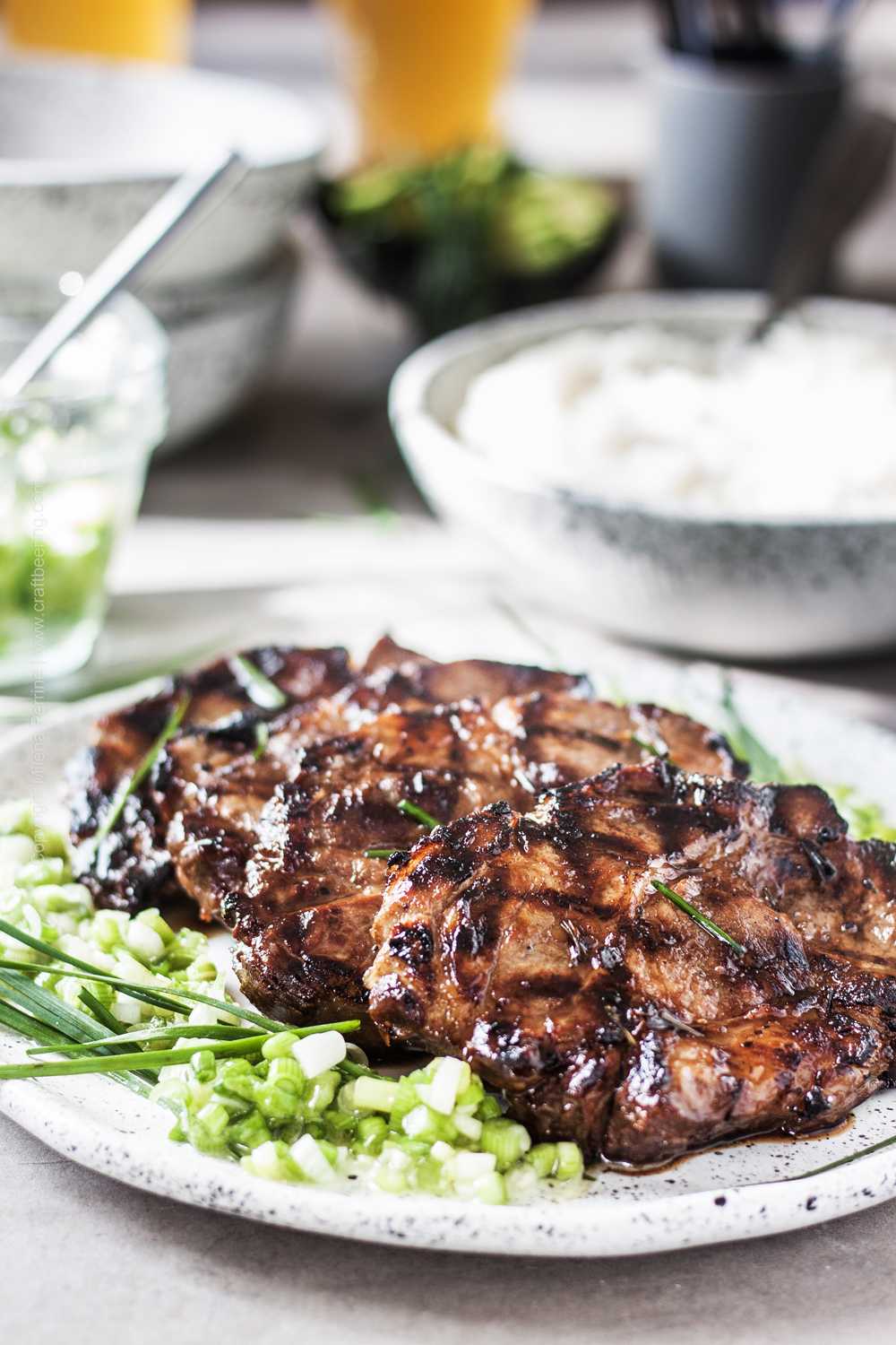 Grilled pork collar chops in Vietnamese marinade, served with scallion ginger sauce and rice.