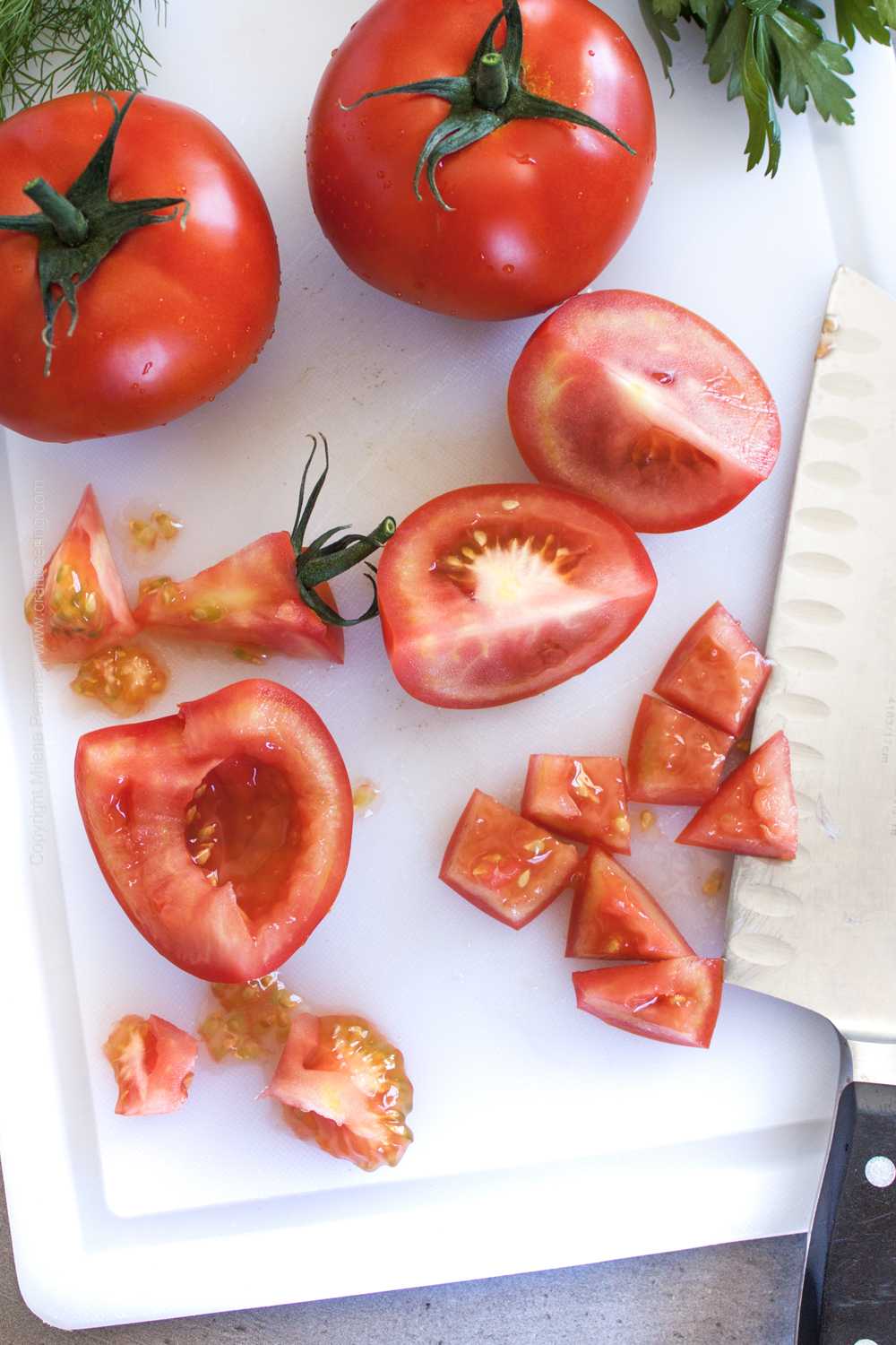 Tomato in various stages of cutting to demonstrate appropriate cut for Shopska salad. 