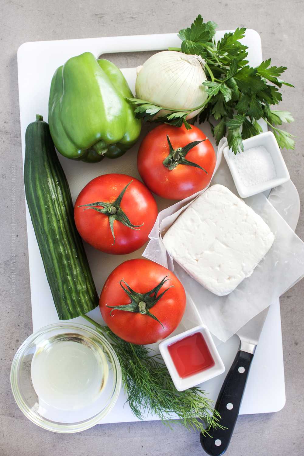Ripe tomatoes, cucumber, feta cheese and other ingredients for cucumber tomato salad. 