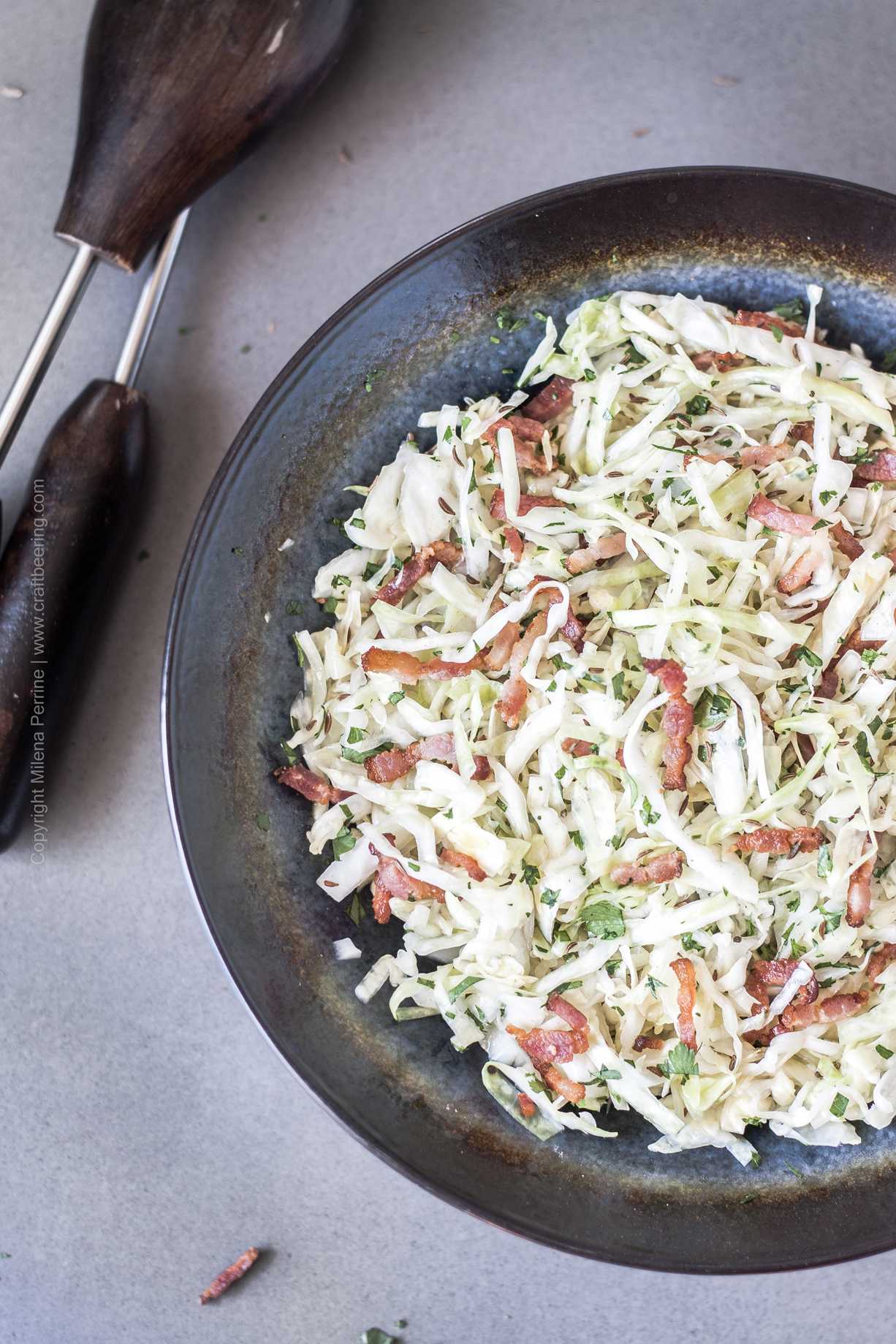 German coleslaw with white cabbage and bacon (weisskrautsalat) and caraway seed.