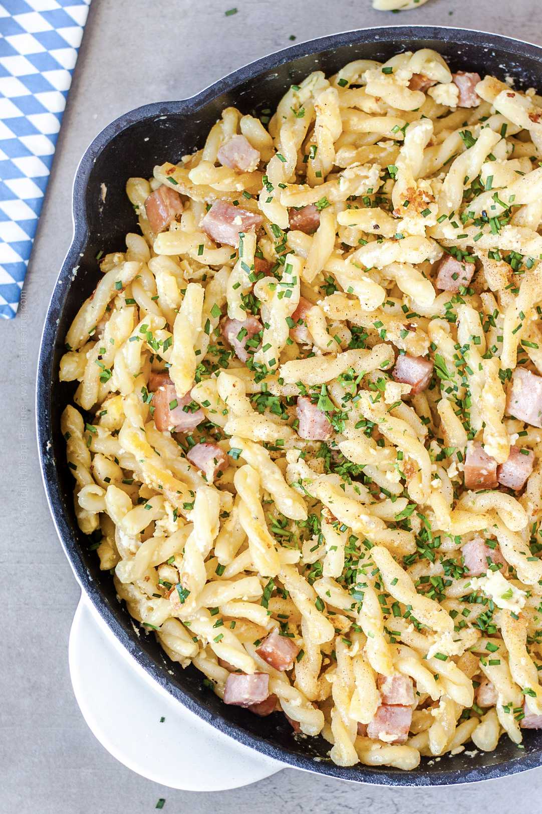 Gemelli short cut pasta, pan fried with ham, egg and cream. Known as Schinkennudeln this is classic beer garden food and a family favorite across Germany.