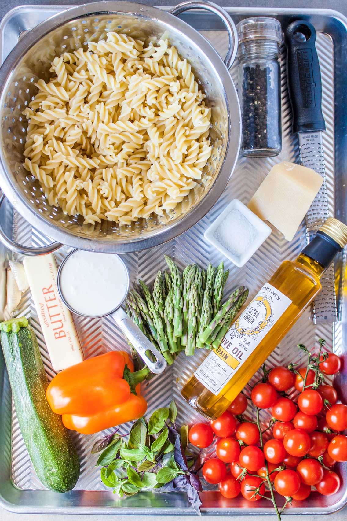Raw ingredients for pasta primavera - spiral short cut noodles, veggies, cream, parmesan, butter