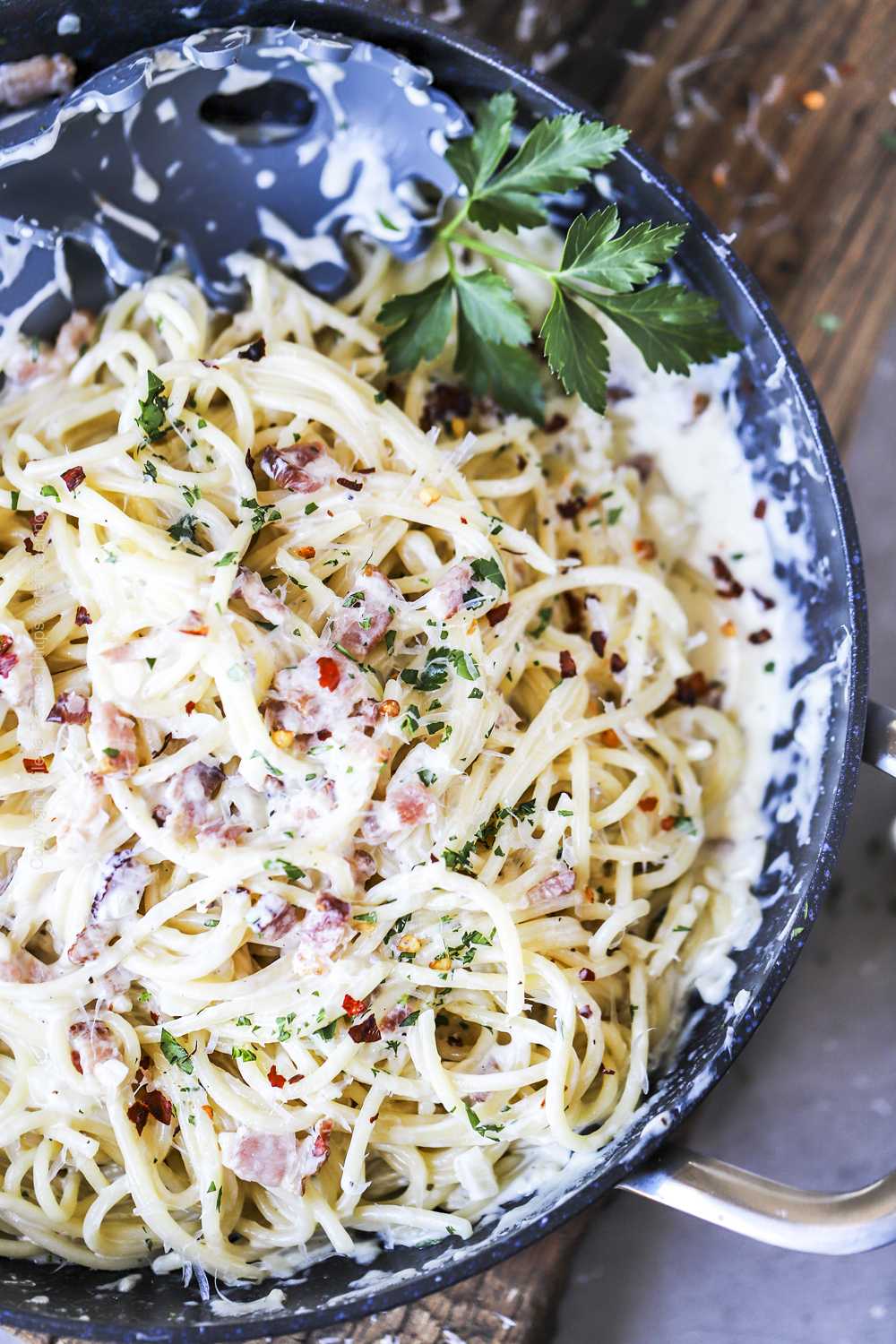 Pasta tossed in creamy bacon sauce garnished with parsley and red pepper flakes. 