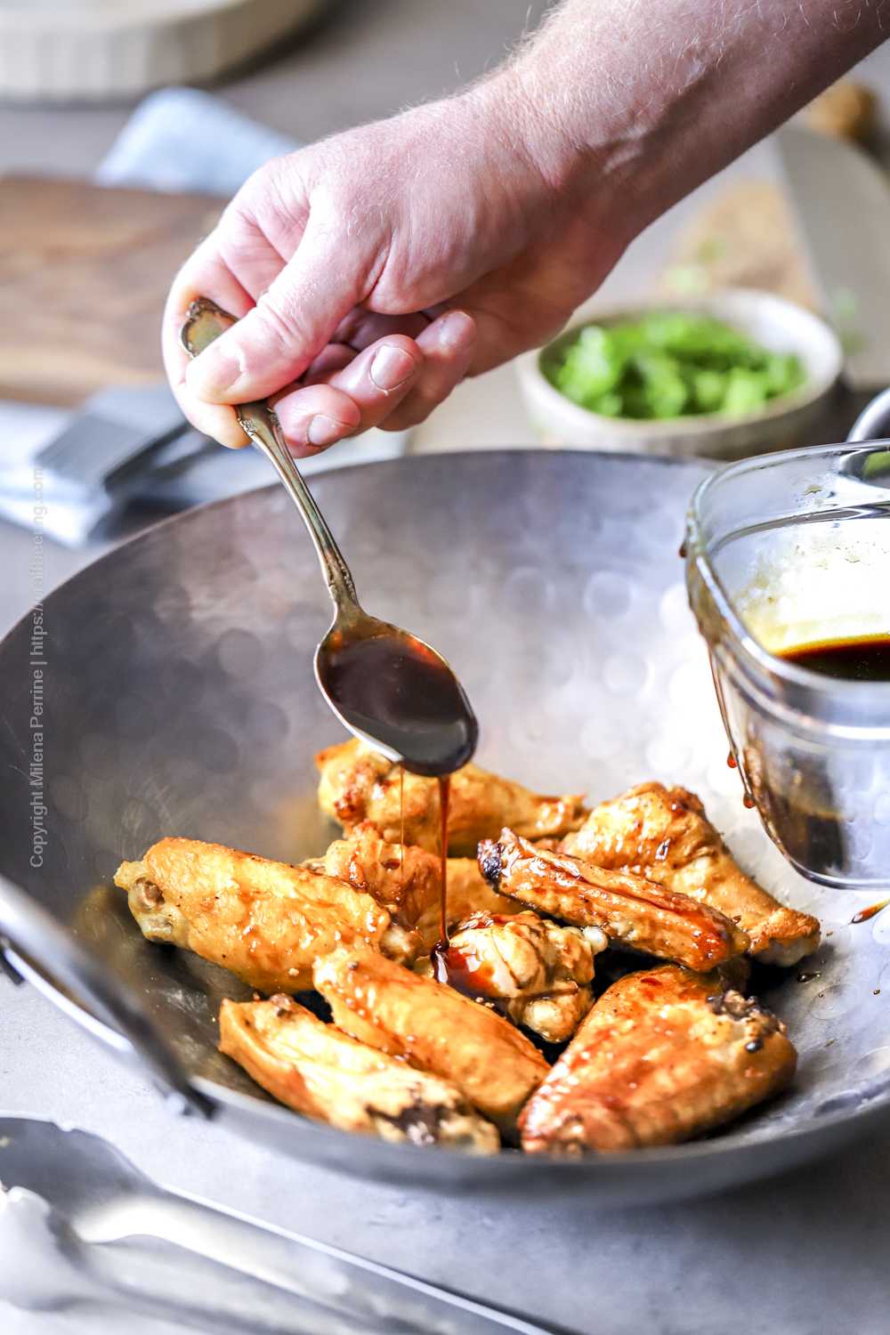 Bourbon sauce drizzled over baked chicken wings.