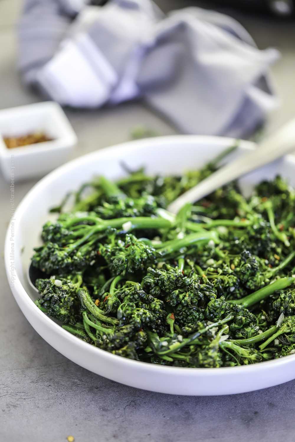 Broccolini cooked with garlic presented as a side to share. 