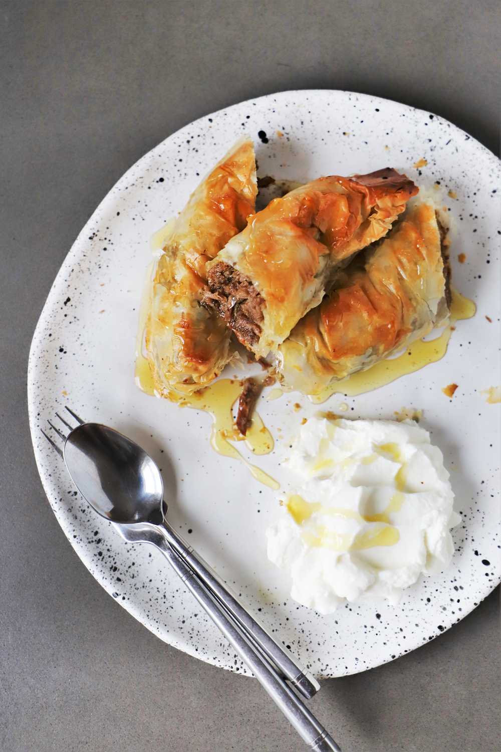 Lamb pie with phyllo, served with honey and yogurt.