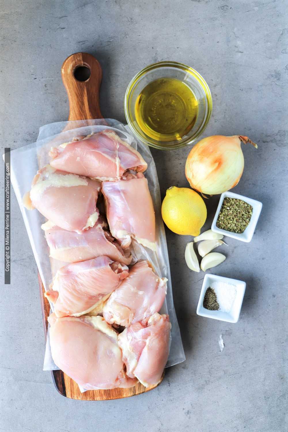 Raw boneless chicken thighs and Greek chicken marinade ingredients.