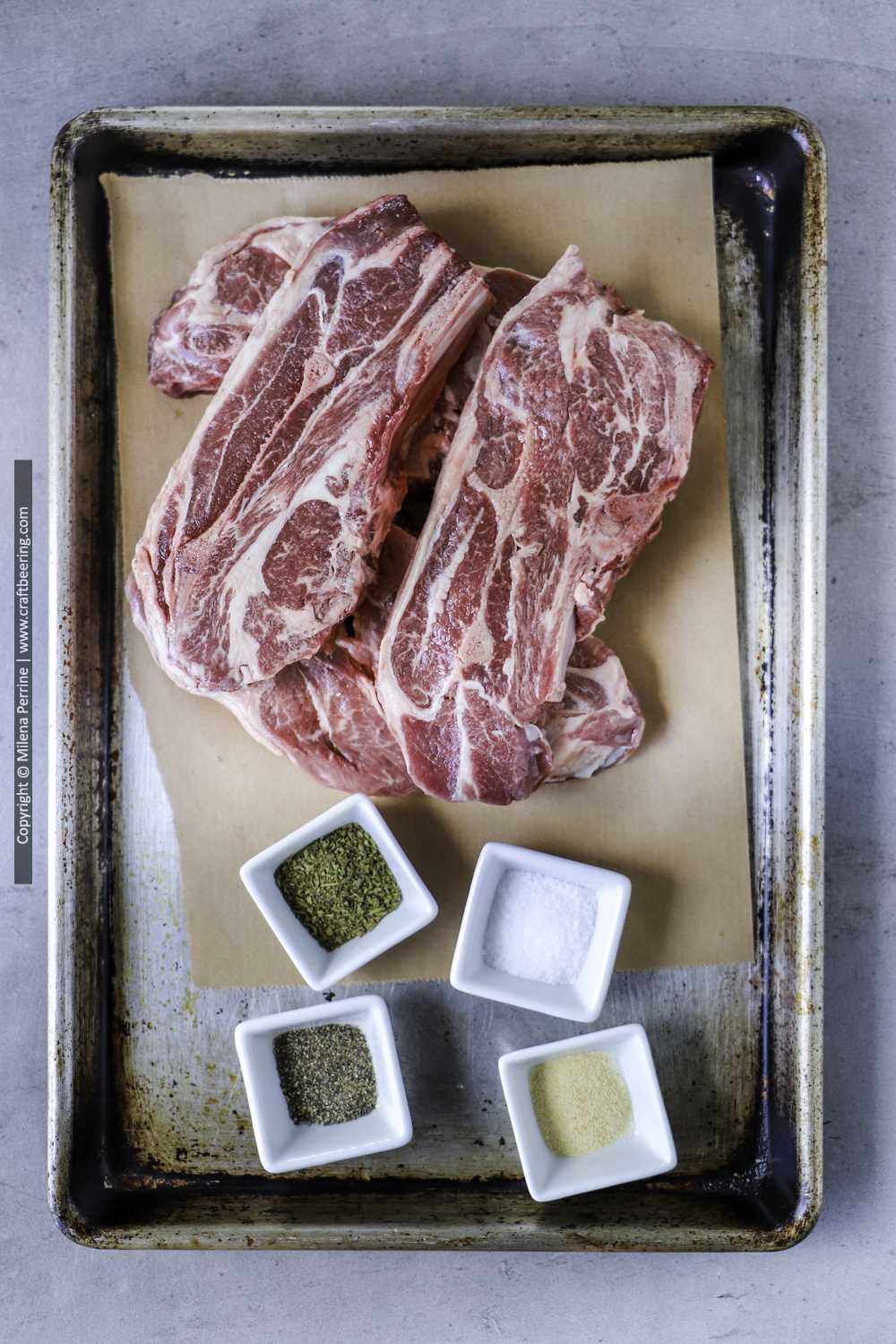 Raw lamb chops with seasoning, ready for smoking.