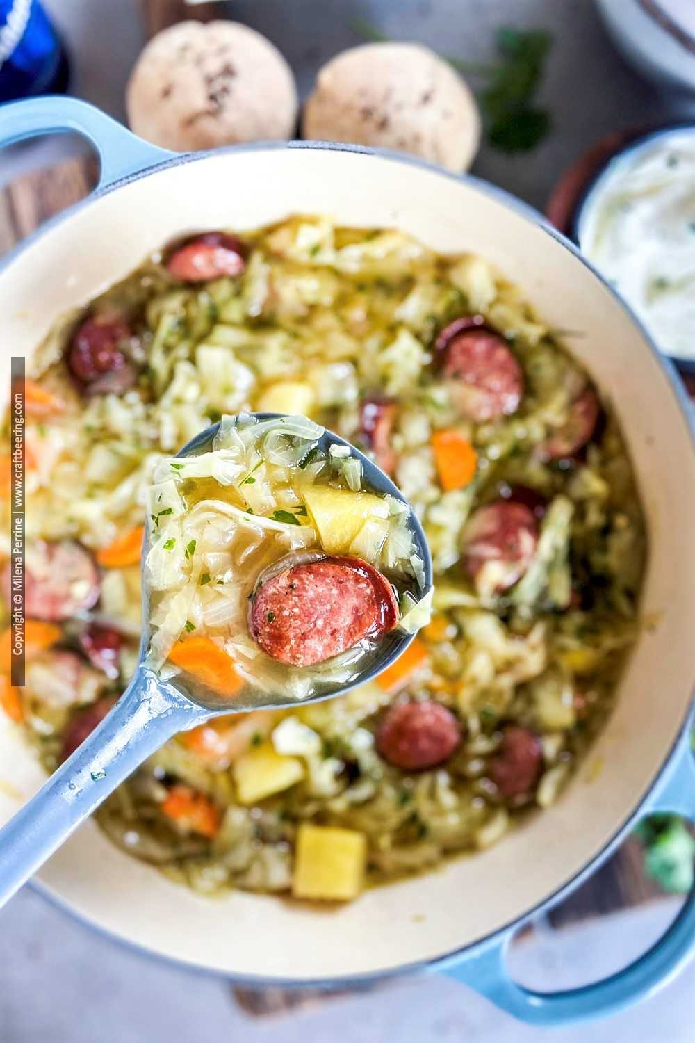 Close up of smoked sausage with cabbage and potatoes. 