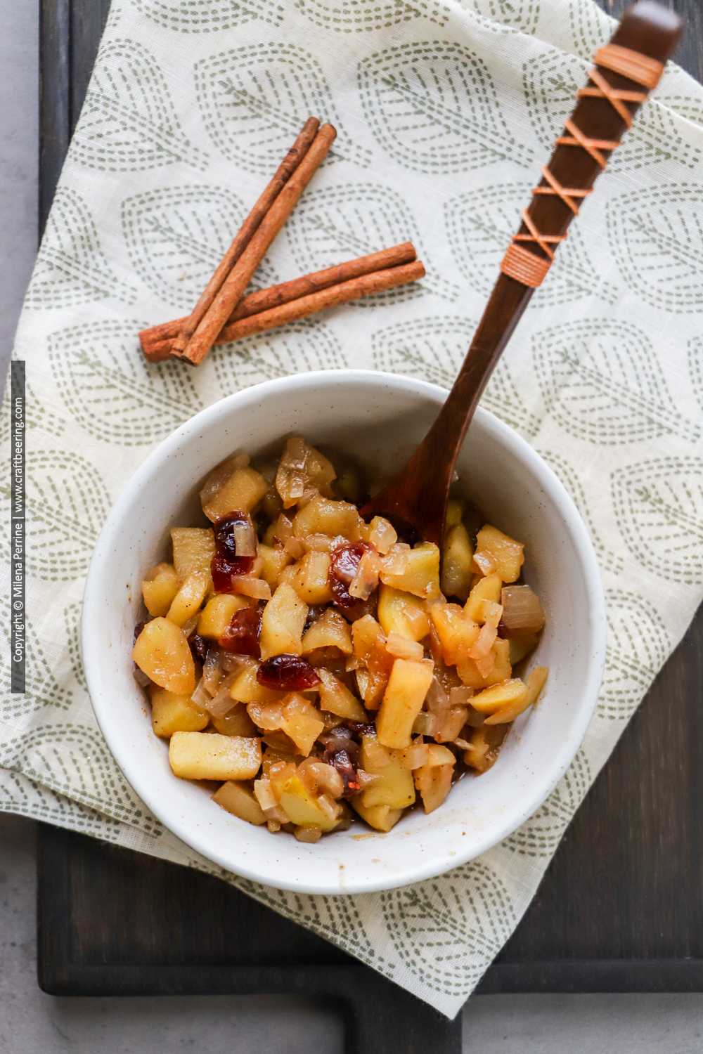 Bowl of apple chutney with dried cranberries.