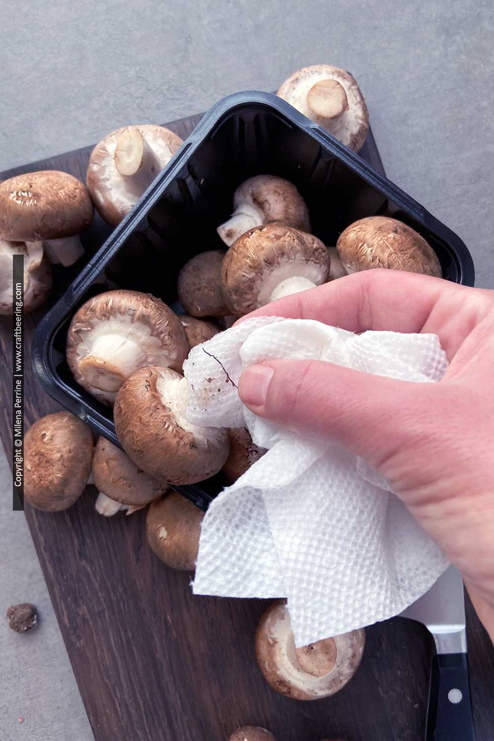 How to cleam mushrooms with a damp paper towel.