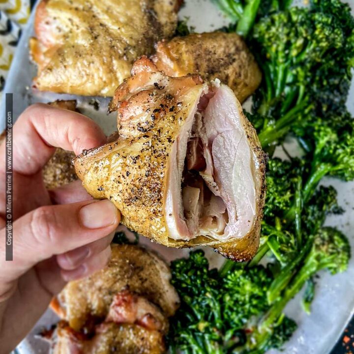 Juicy smoked chicken thighs - cross section showing moist meat and crispy skin.