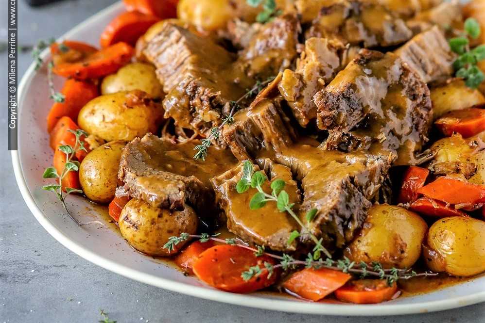 Eye of round roast with vegetables, smothered in gravy.