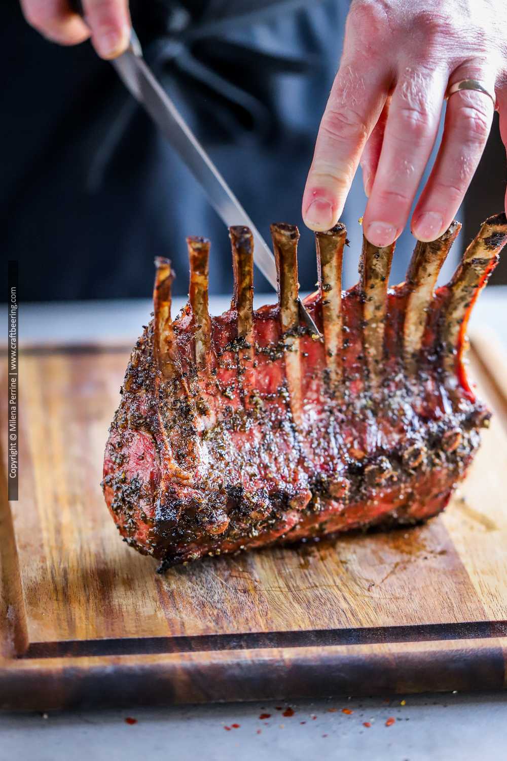 Rack of lamb smoked to perfection is being carved into lamb rib chops