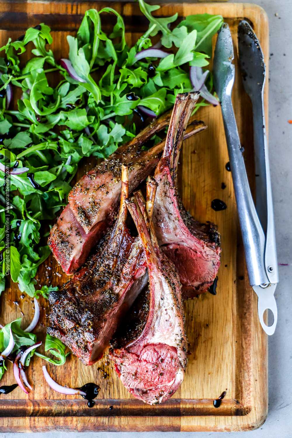 Smoked lamb rib chops just carved from a full rack.