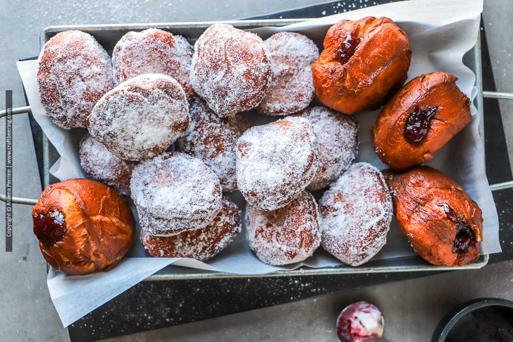 Malasadas Portuguese donuts coated in sugar and filled with fruit puree.