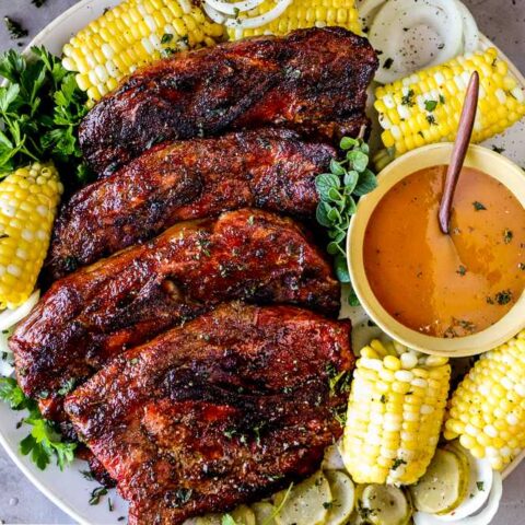 Smoked pork steaks served with barbecue sauce