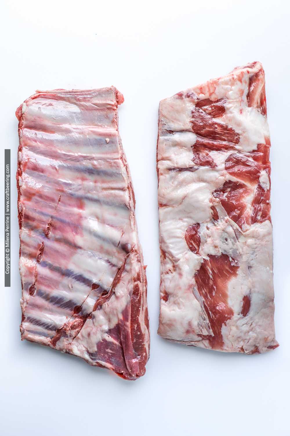 Raw racks of lamb ribs side by side - top and bottom.