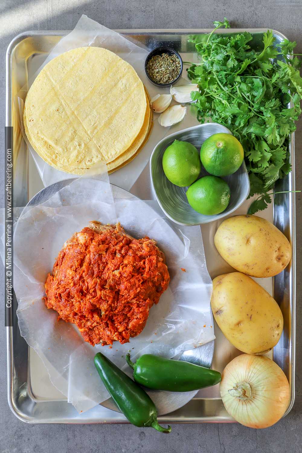 Raw Mexican chorizo, tortillas, jalapenos, limes, clilantro, onion, garlic and potatoes for tacos de chorizo con papas.